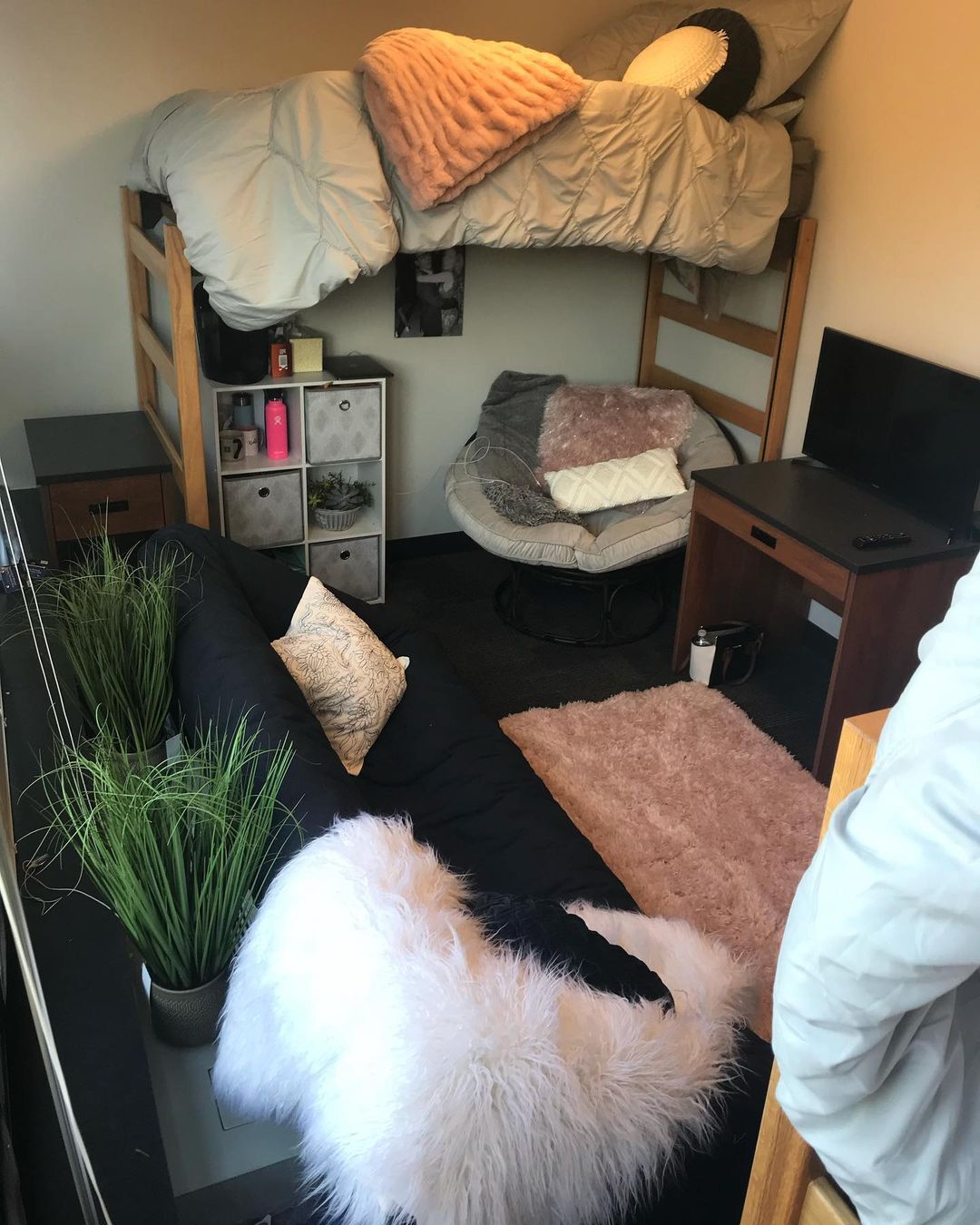 Interior dorm room showing beds, tables and decorations